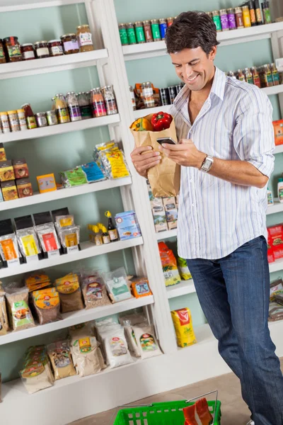 Man With Grocery Bag Checking List In Supermarket — Stock Photo, Image