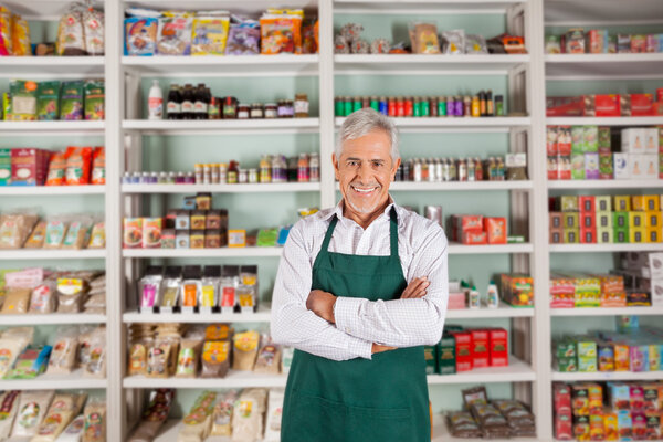 Senior Male Owner Standing In Supermarket