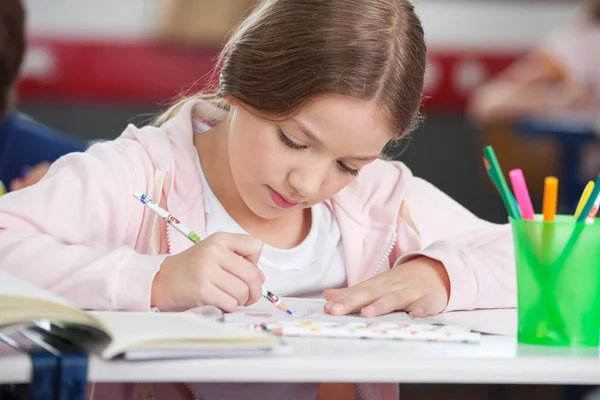 Schoolgirl Drawing At Desk — Stock Photo, Image