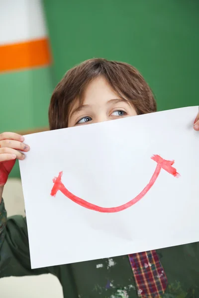 Boy Holding Paper With Smile Drawn On It — Stock Photo, Image