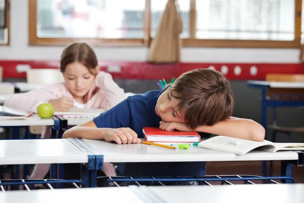 Boy Sleeping On Desk In Classroom — Stock Photo, Image