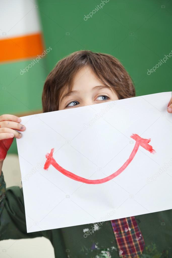 Boy Holding Paper With Smile Drawn On It