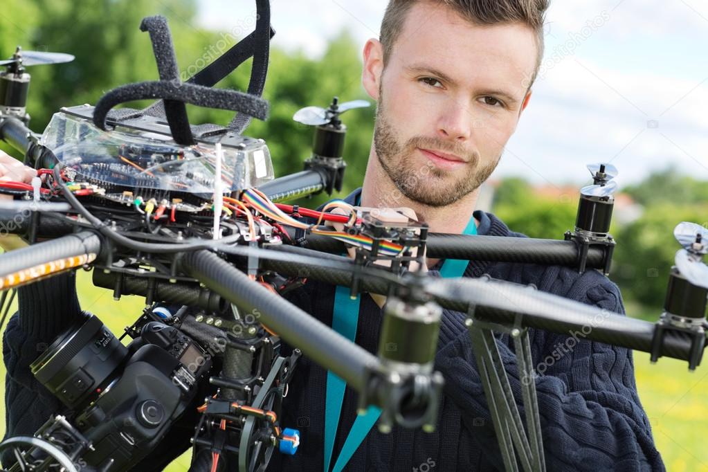 Male Engineer With UAV Helicopter in Park