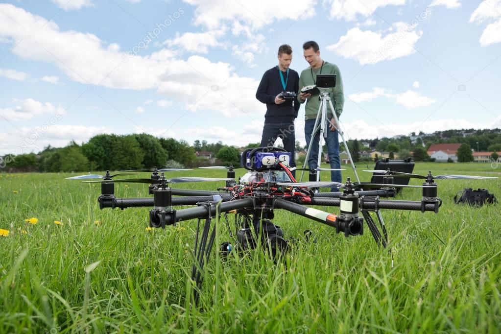 UAV Octocopter And Technicians At Park