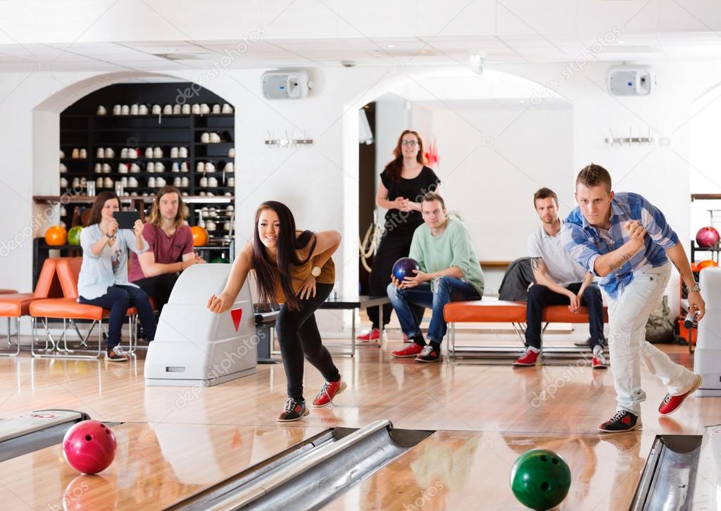 Young Friends Playing in Bowling Alley