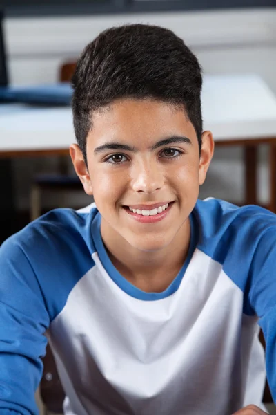 Teenage Schoolboy Sitting In Classroom — Stock Photo, Image