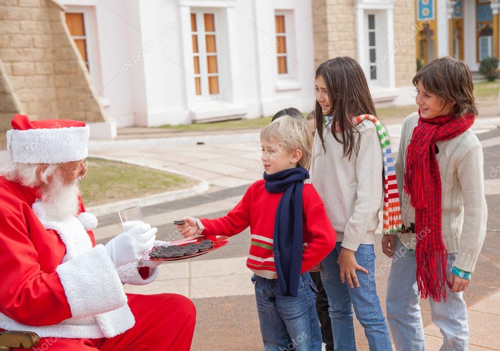 Children Taking Biscuits From Santa Claus