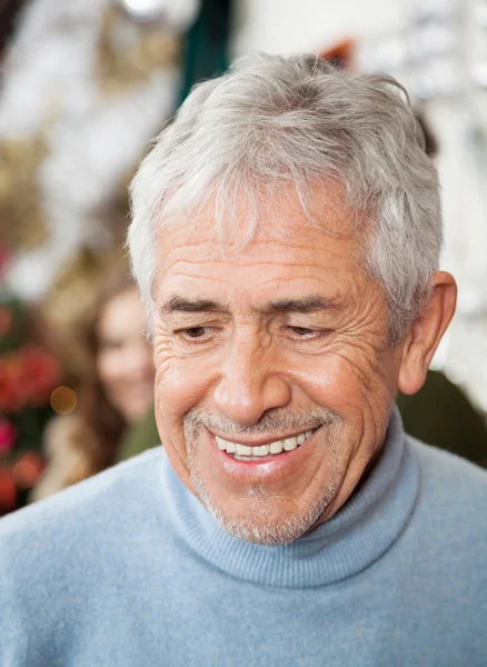 Senior Man In Christmas Store — Stock Photo, Image