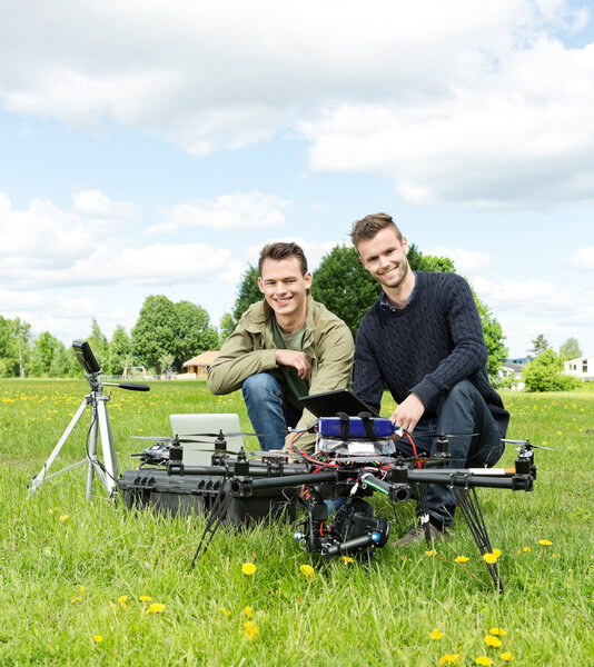 Engineers With Laptop And Digital Tablet By UAV