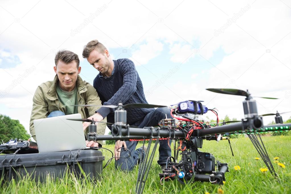 Engineers Using Laptop By UAV Octocopter