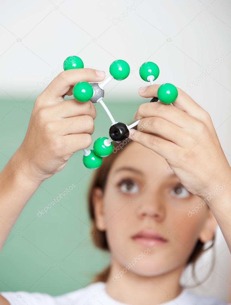 Teenage Schoolgirl Examining Molecular Structure