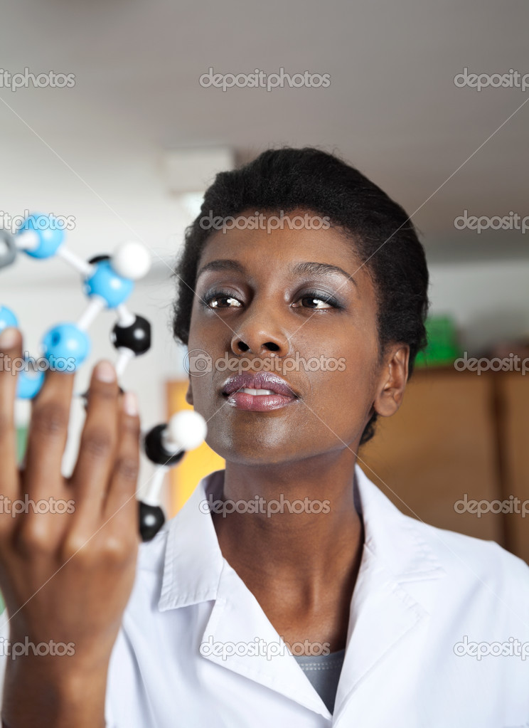 Teacher Looking At Molecular Structure In Science Lab