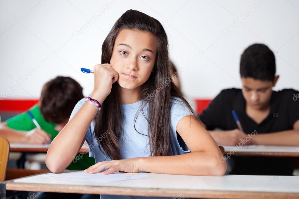 Teenage Schoolgirl Sitting At Desk