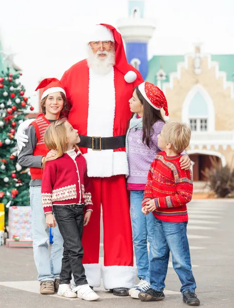 Santa Claus With Children Standing In Courtyard Stock Image
