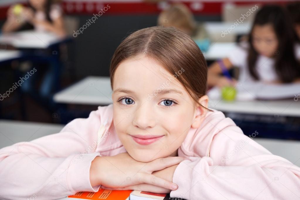 Schoolgirl Resting Chin On Hands In Classroom
