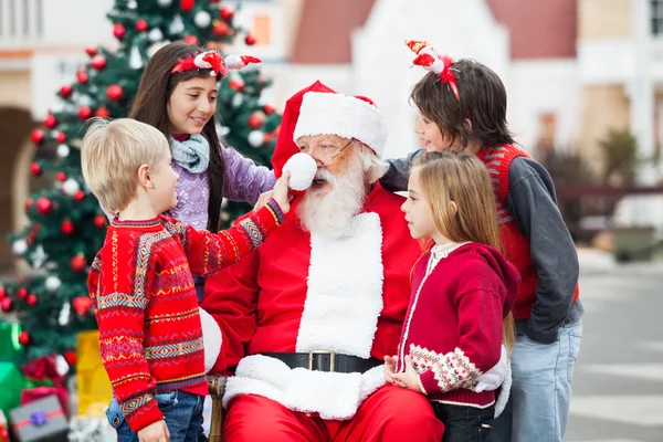 Barn som leker med jultomten hatt — Stockfoto