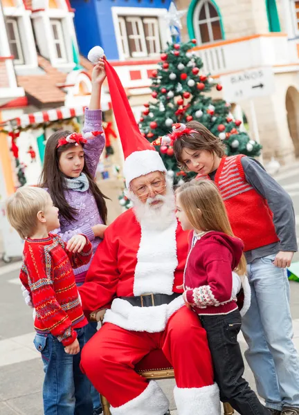 Santa Claus And Children In Courtyard Stock Photo
