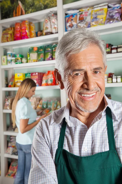 Proprietario Con Femmina Cliente Shopping In background — Foto Stock