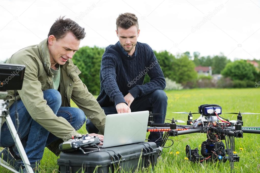 Technicians Using Laptop By UAV Drone