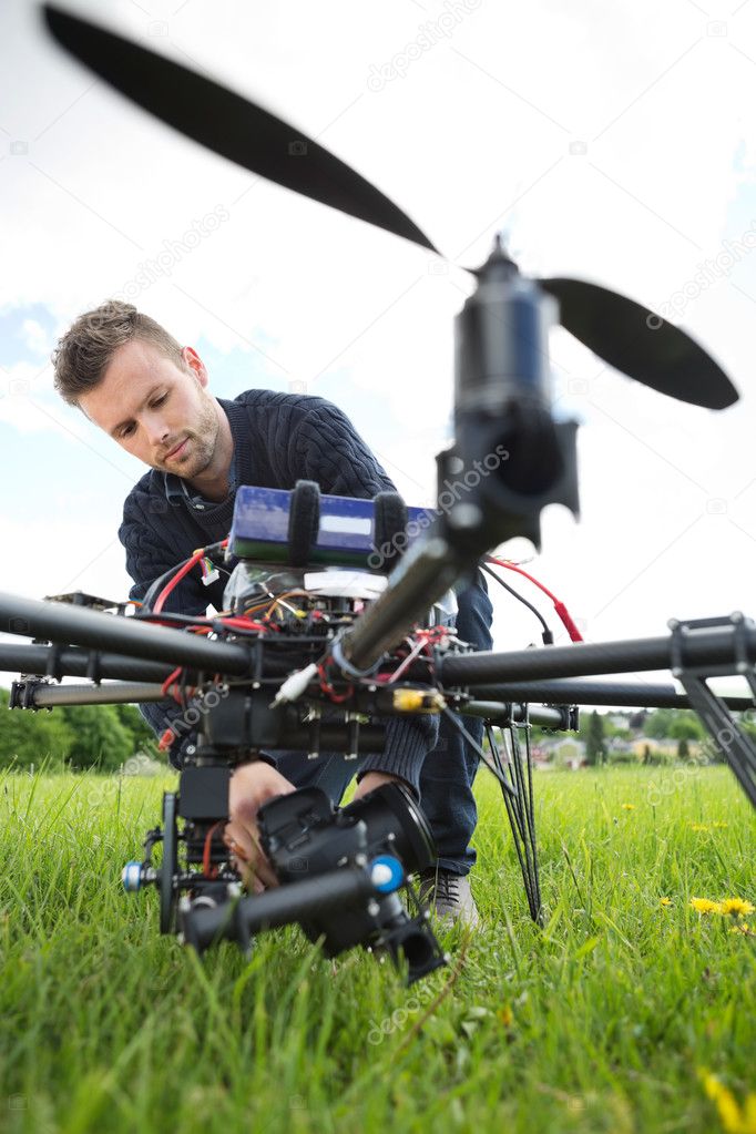 Technician Fixing Camera On Spy Drone