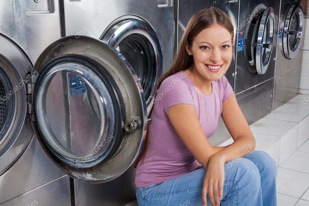 Woman Sitting Against Washing Machines — Stock Photo © SimpleFoto 33209127