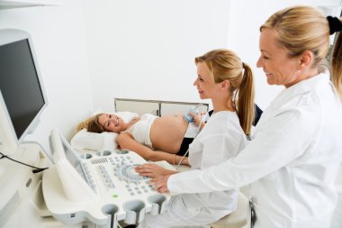 Gynecologists Performing An Ultrasound clipart