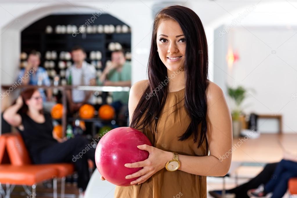 Happy Woman Holding Bowling Ball in Club