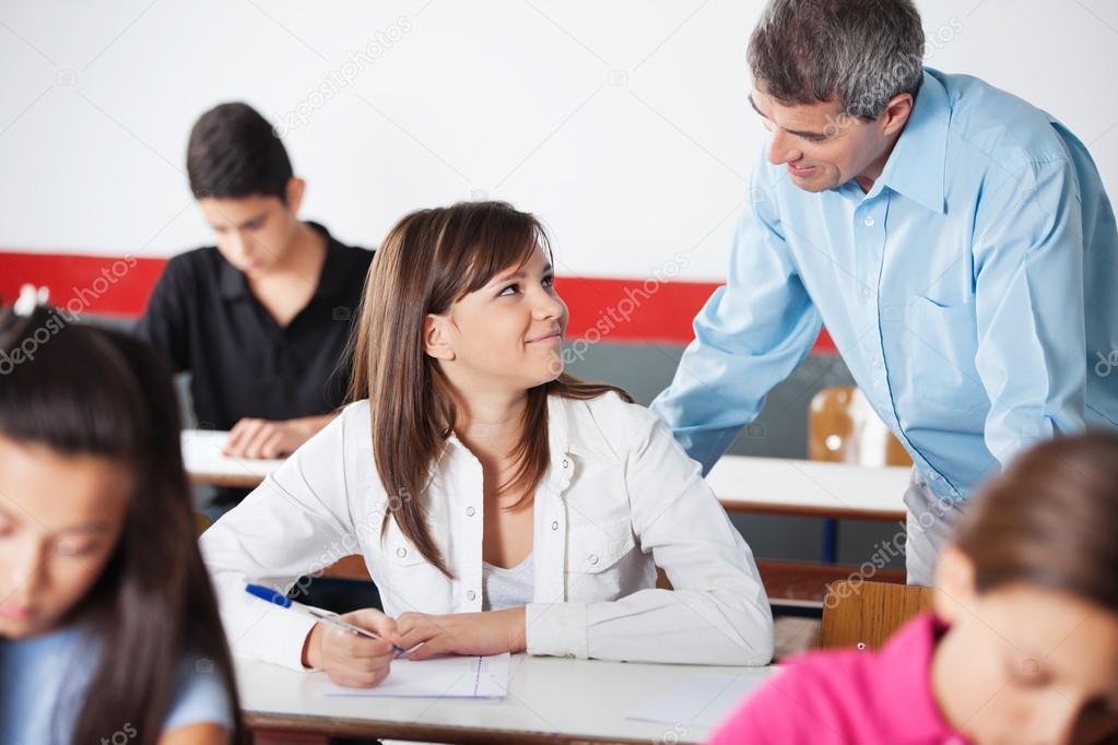 Professor And Schoolgirl Looking At Each Other During Examinatio