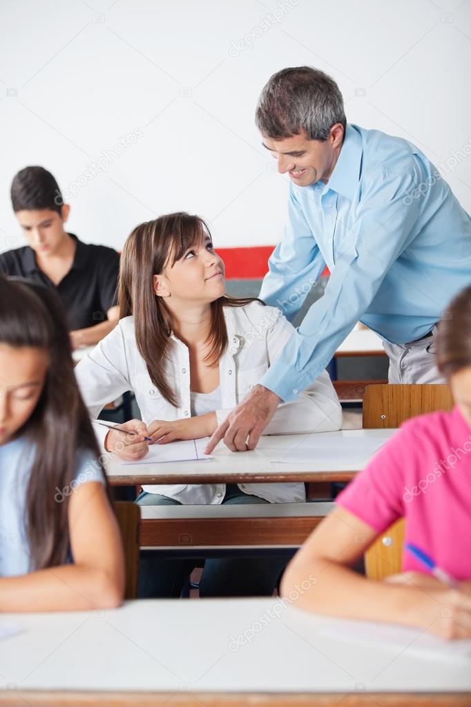Professor Pointing At Paper While Student Looking At Him