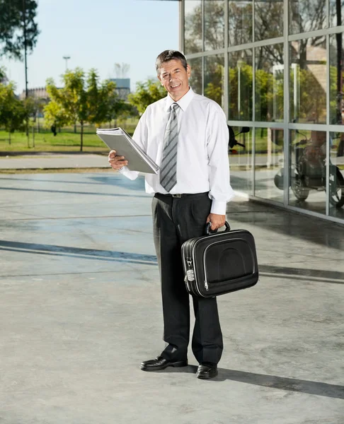 Confident Teacher With Laptop Bag And Books Standing On College — Stock Photo, Image