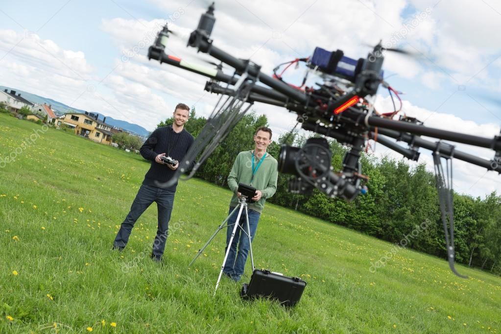 Engineers Flying UAV Helicopter in Park