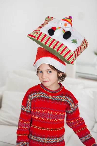 Boy Balancing Cushion On Head During Christmas — Stock Photo, Image