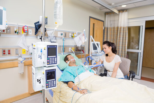 Worried Woman Looking At Critical Patient