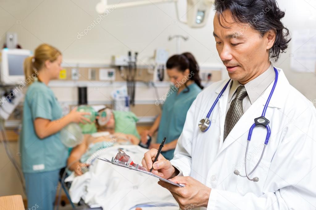 Doctor Writing Notes in Emergency