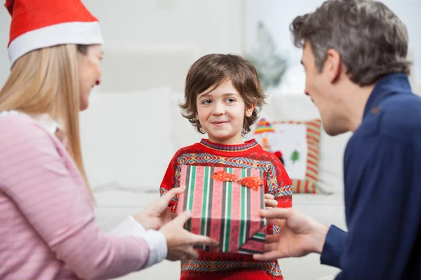 Boy Receiving Christmas Gift From Parents — Stock Photo, Image