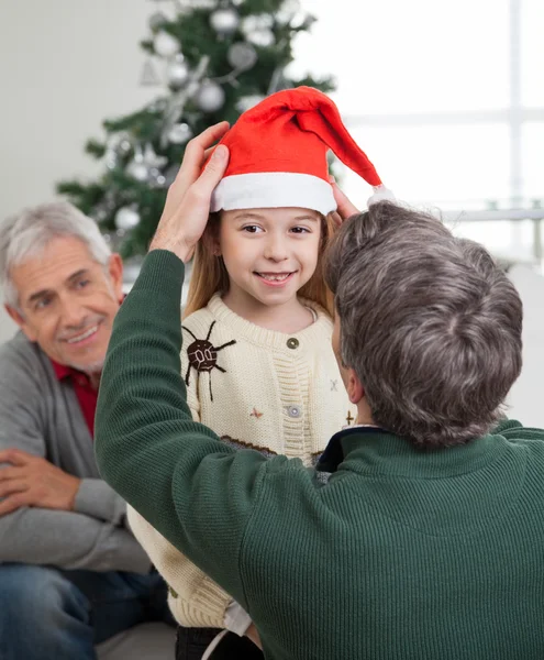 Father Adjusting Girl's Santa Hat — Stock Photo, Image