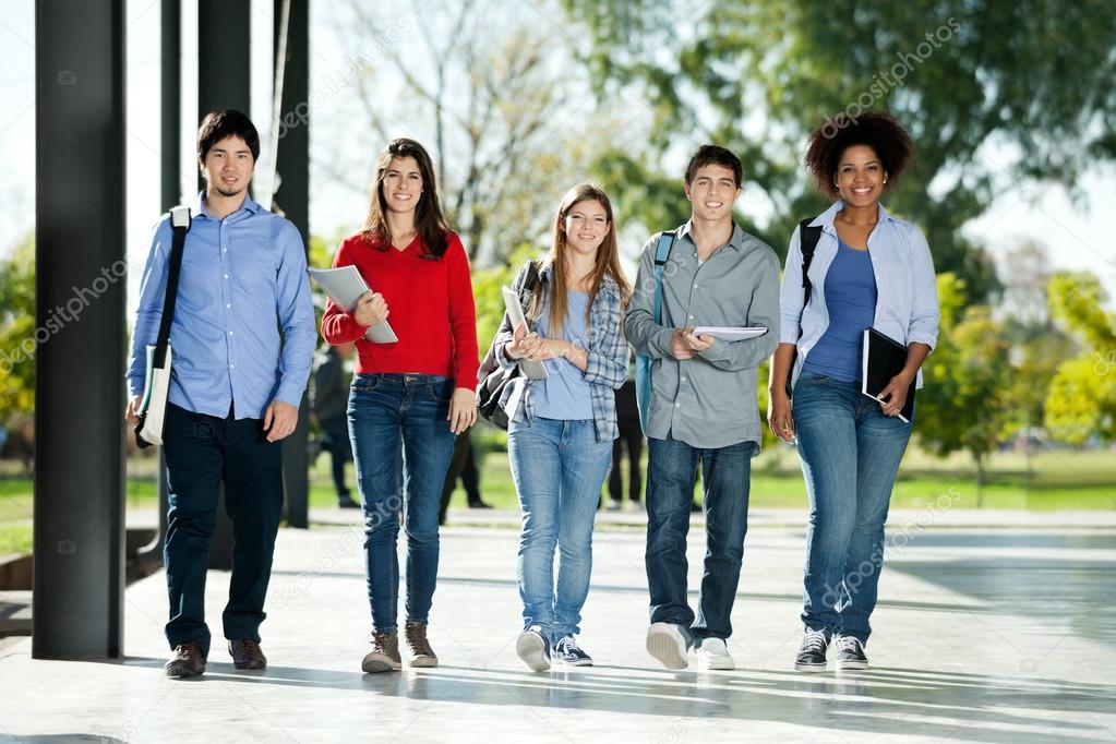 Confident Students Walking In A Row On Campus