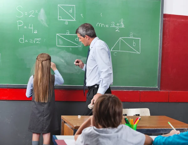 Girl Solving Mathematics On Board With Teacher — Stock Photo, Image