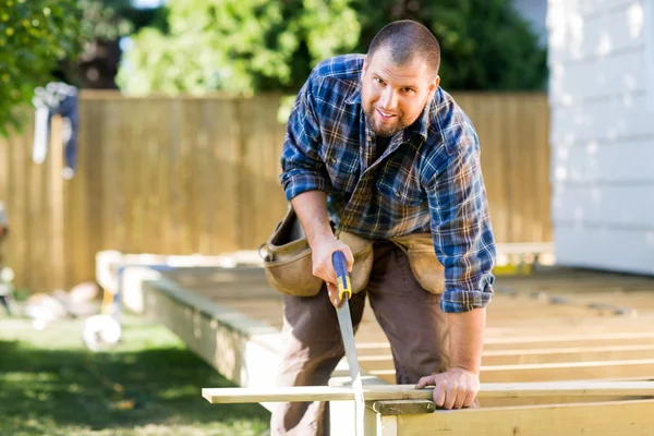 Manual Worker Sawing Wood At Construction Site — Stock Photo, Image