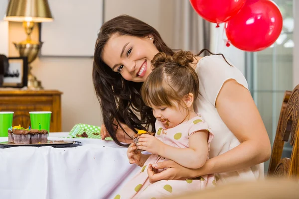 Vrouw met dochter eten verjaardagscake — Stockfoto