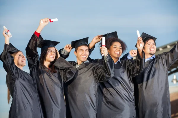 Students Holding Certificates Against Sky — Stock Photo, Image