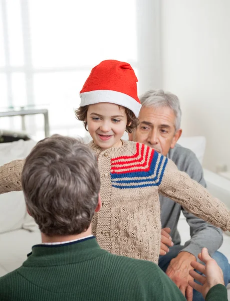 Son In Santa Hat About To Embrace Father — Stock Photo, Image