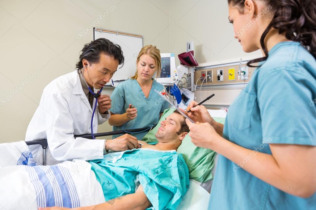 Doctor And Nurses Examining Patient