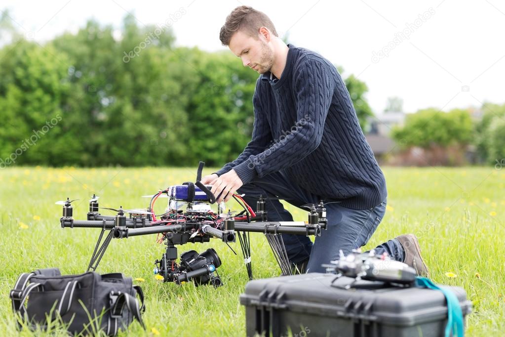 Engineer Preparing Surveillance Drone in Park