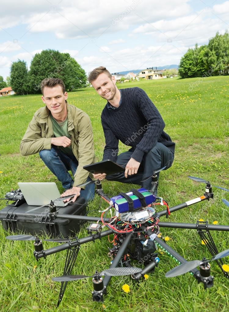 Technicians With Laptop And Digital Tablet By UAV