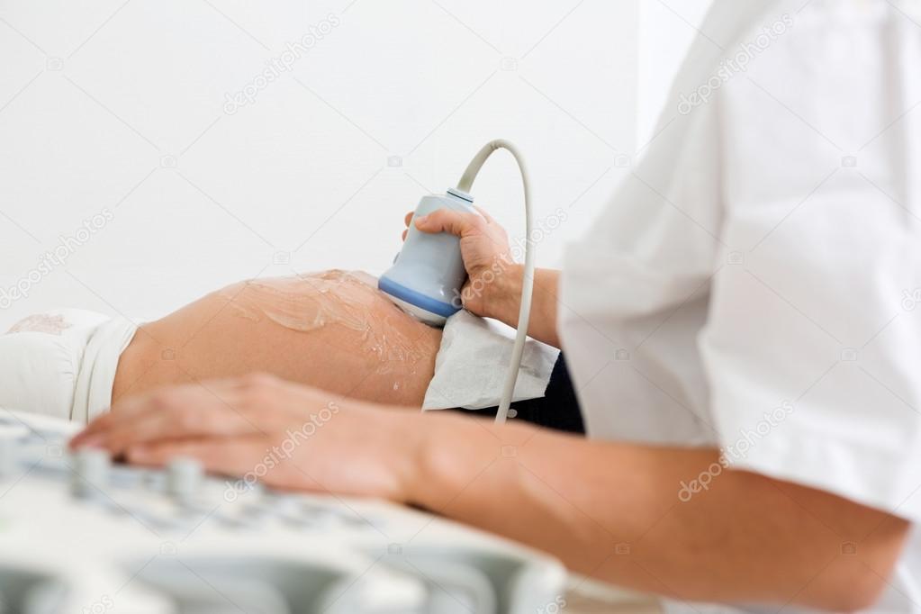 Doctor Examining Pregnant Belly By Ultrasonic Scan