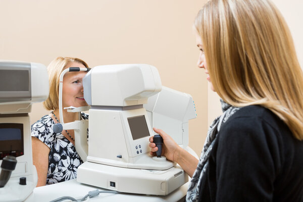 Optometrist Using Tonometer to Measure Patients Eye Pressure