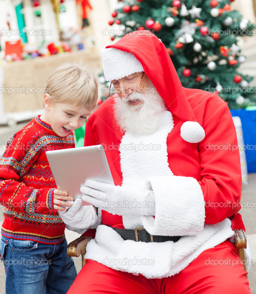 Boy And Santa Claus Using Digital Tablet