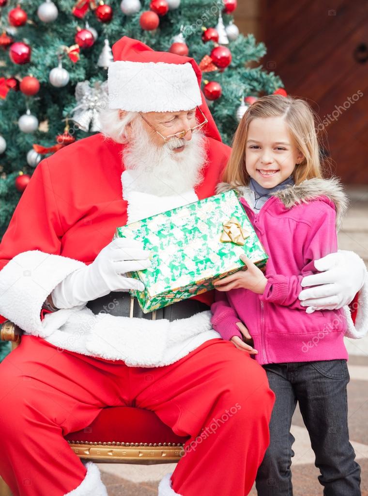 Girl Taking Present From Santa Claus