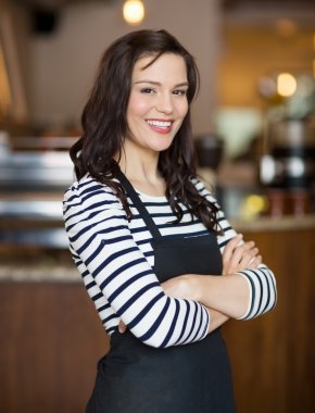 Happy Waitress Standing In Cafe